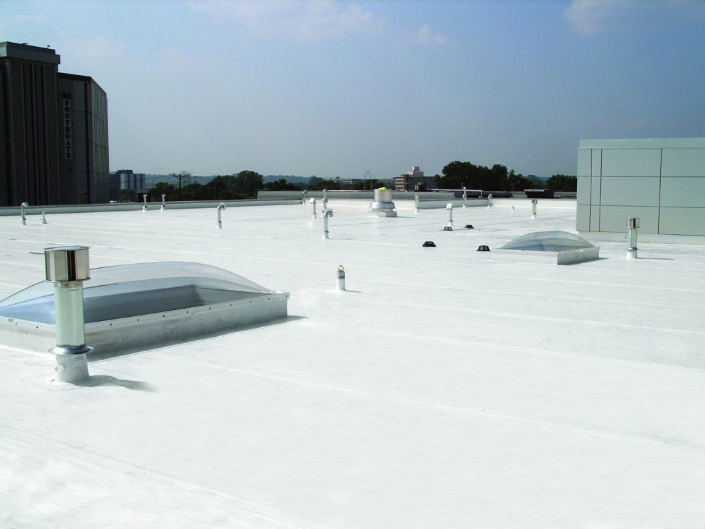 A completed white commercial roofing project.